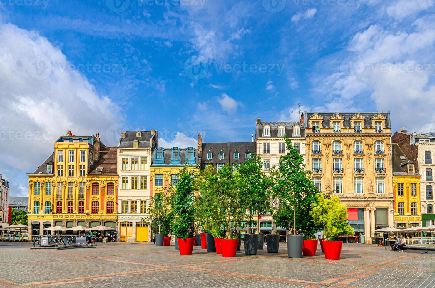 Lille cityscape, La Grand Place square General de Gaulle, historical monument Flemish mannerist architecture style, row of buildings, trees in pots, Nord department, Hauts-de-France Region, France photo