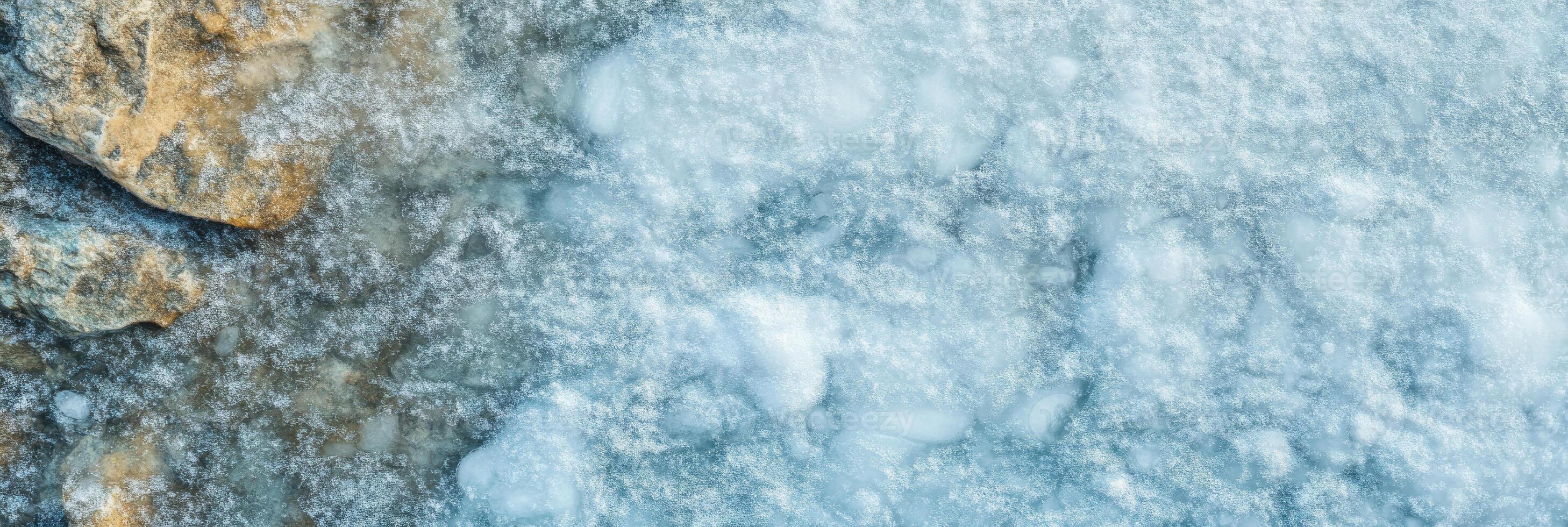 Abstract texture of frozen ice and rocky surface captures winter's crystalline beauty photo