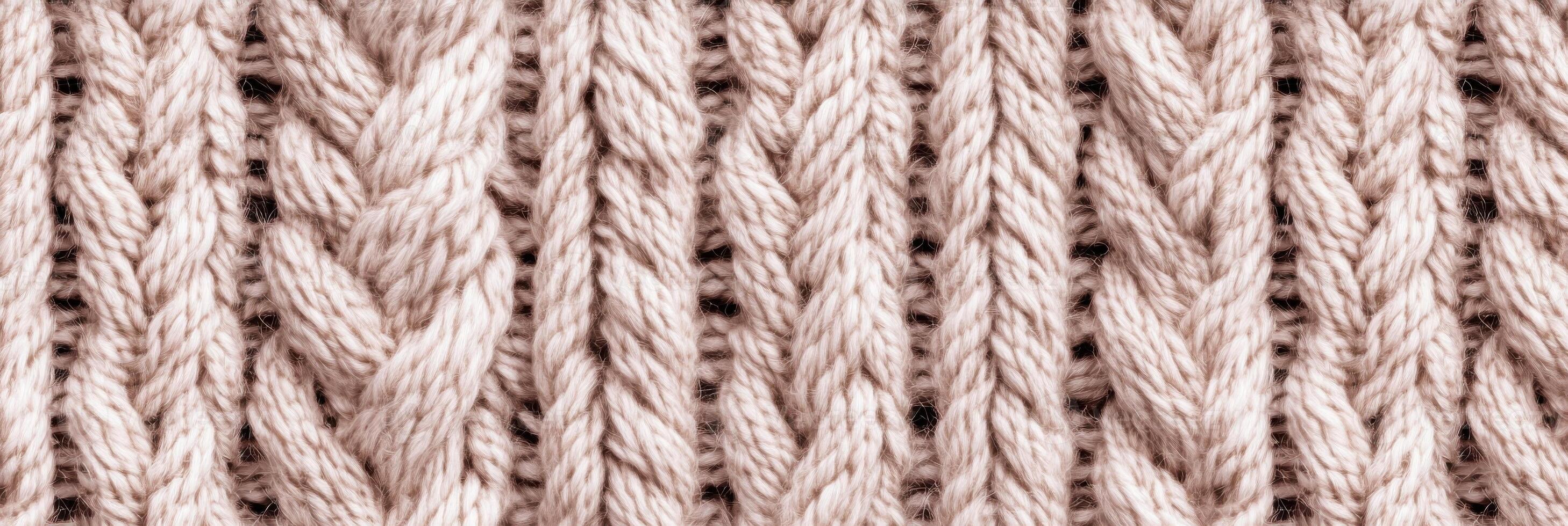 Close-up of beige knitted woolen textile, showcasing intricate patterns and weaving photo