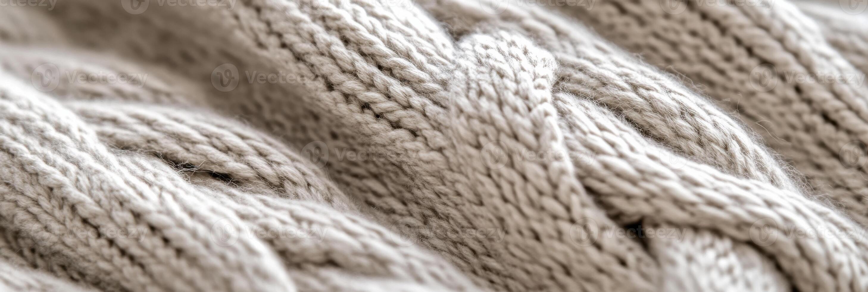 Close-up of beige knitted woolen fabric showcasing intricate texture pattern photo