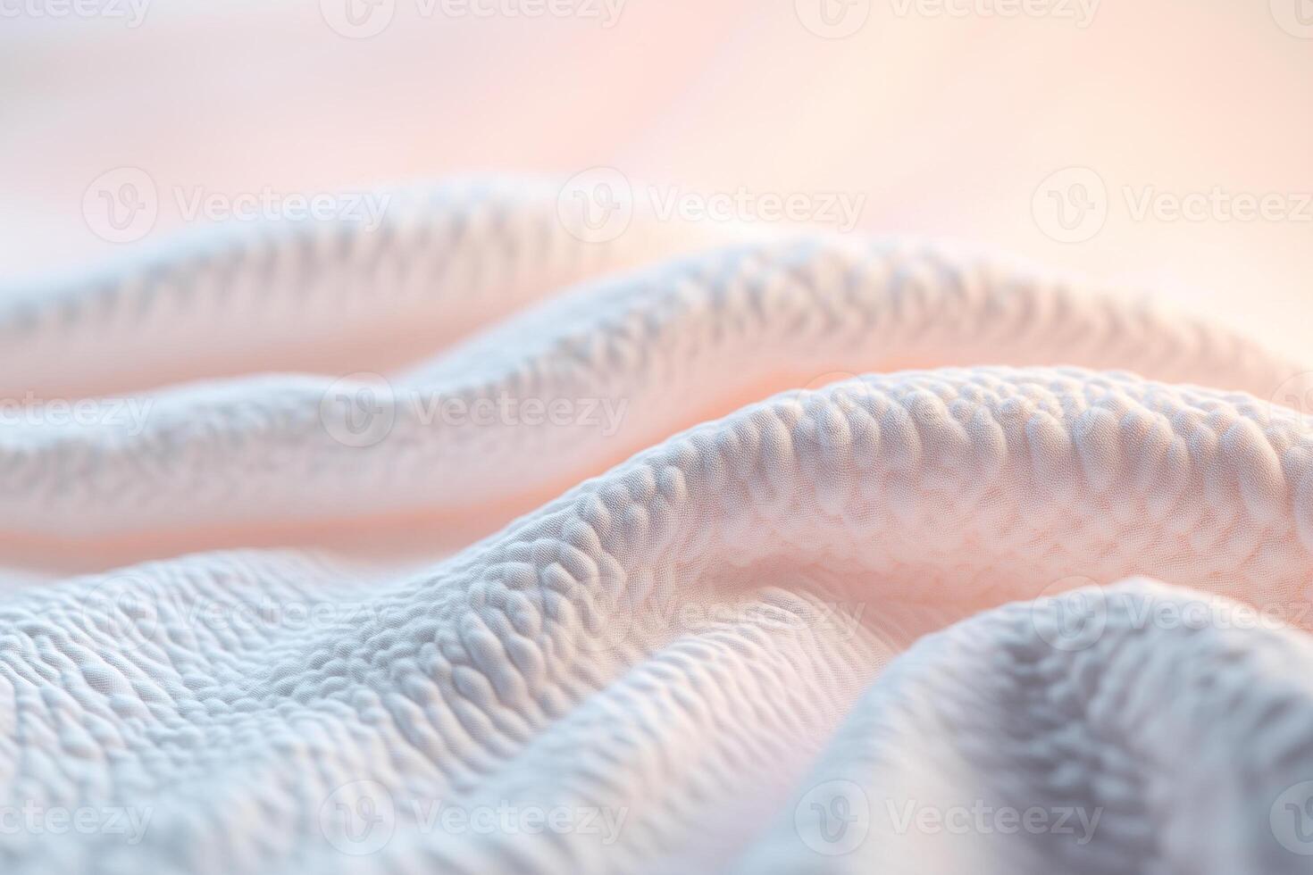 A soft glowing quilt is draped gracefully over a surface, showcasing inviting textures that evoke feelings of comfort and relaxation. The neutral gradient background enhances the soothing atmosphere photo