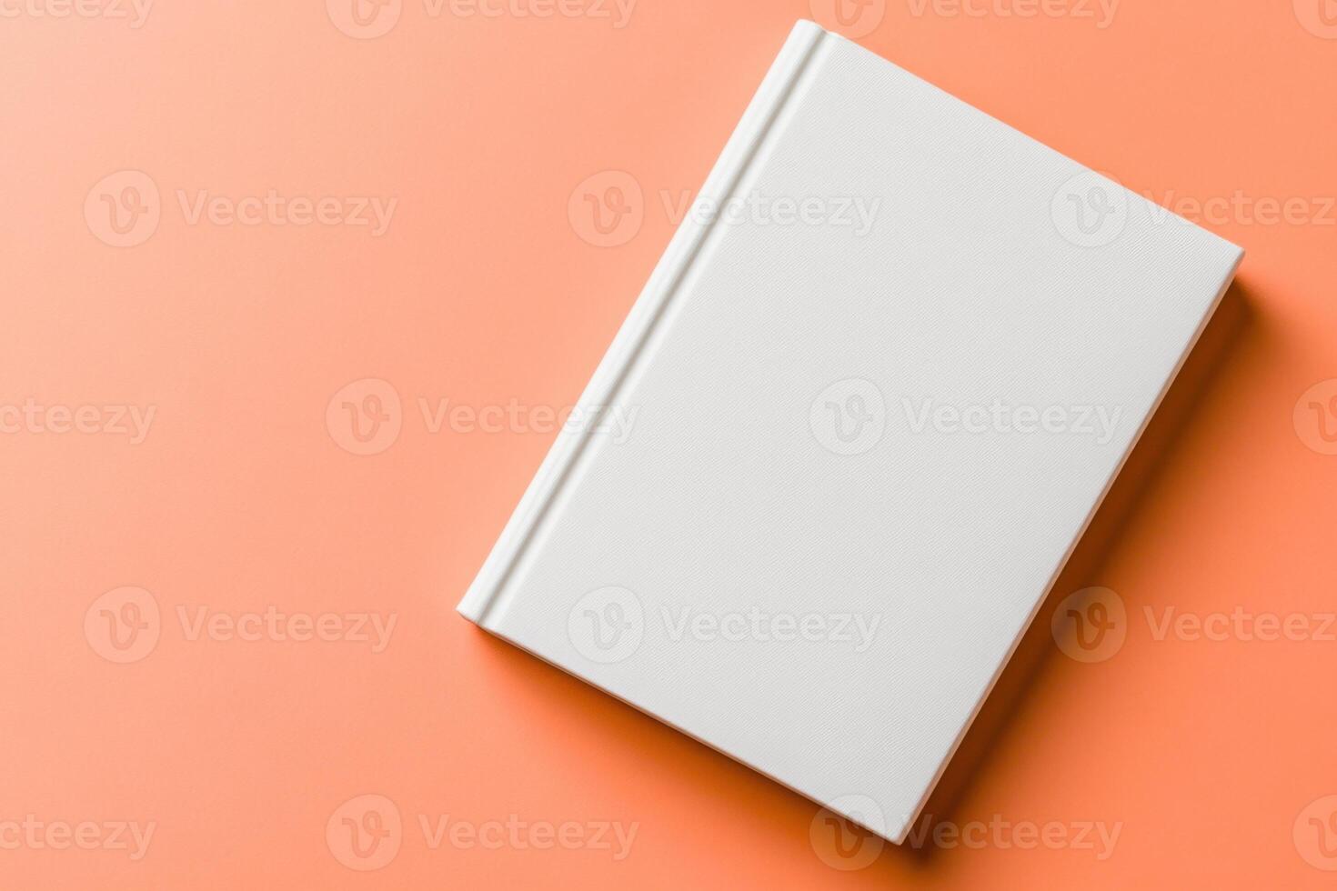 Elegant mockup of a blank white book cover displayed on a soft peach background to highlight its clean design and versatility in presentation photo