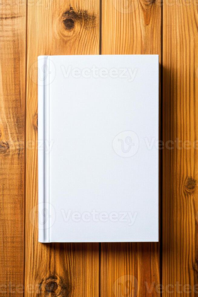 Minimalist book with blank cover on wooden background showcasing simple design for creative mockups or presentations photo