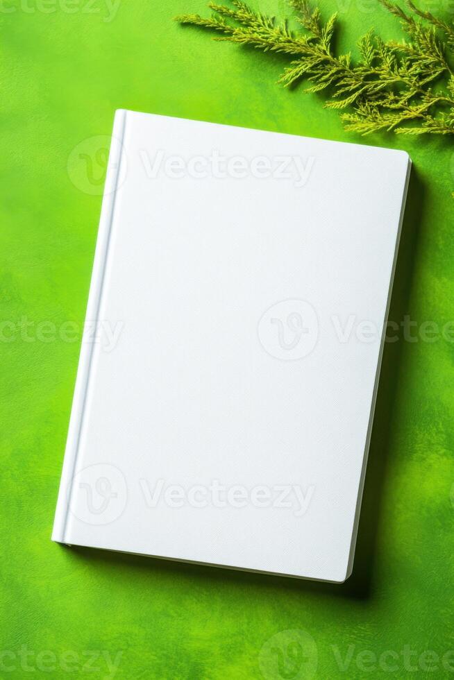 Minimalist book mockup with a blank cover on green background highlighting modern design aesthetics photo