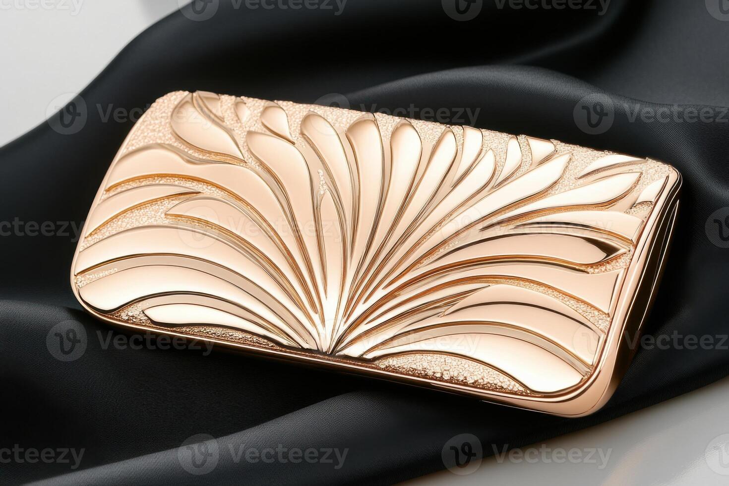 Detailed view of a stylish rose gold clutch showcasing intricate patterns on black satin fabric for a luxurious touch photo