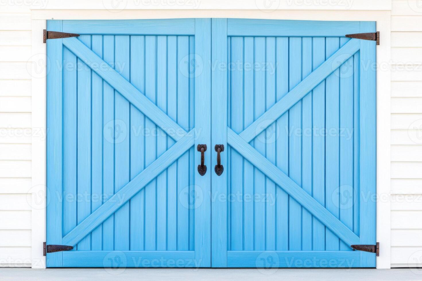 Rustic wooden barn doors painted in weathered blue with rusty metal hinges and soft shadows create a nostalgic countryside backdrop photo