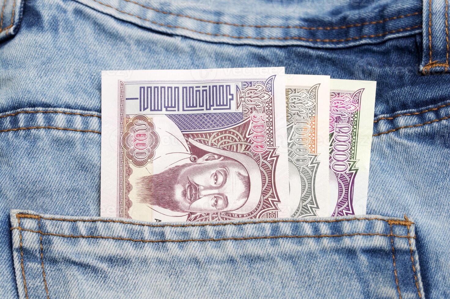 Mongolian tugrik in the pocket of blue jeans photo