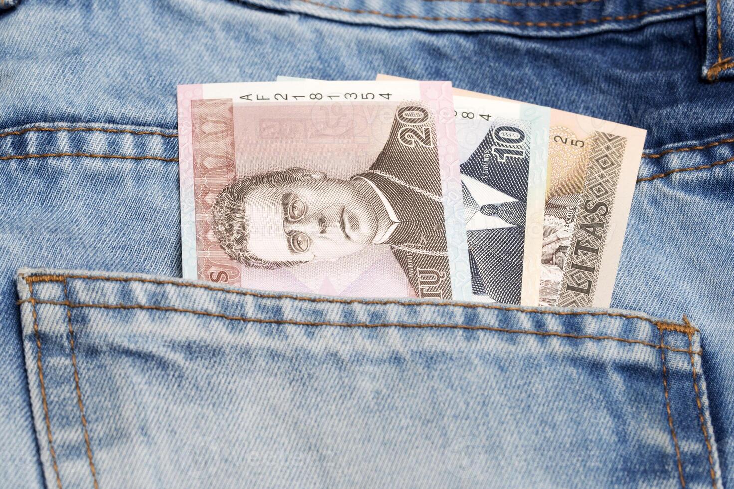 Lithuanian litas in the pocket of blue jeans photo