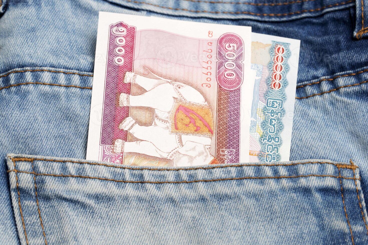 Myanmar kyat in the pocket of blue jeans photo