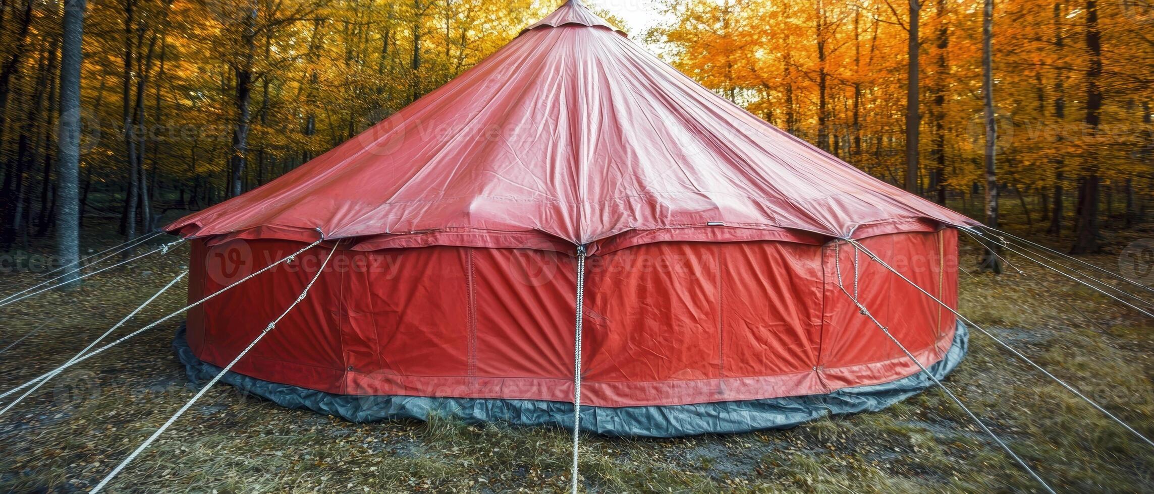 Red tent in autumn forest photo
