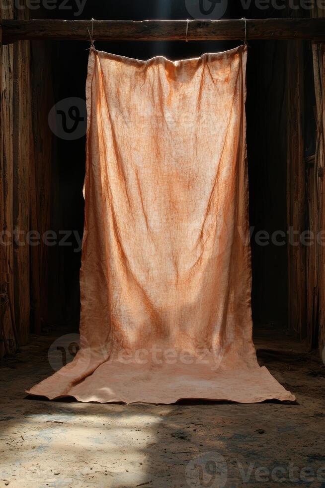 Draped fabric in earthy tones hanging in rustic setting photo