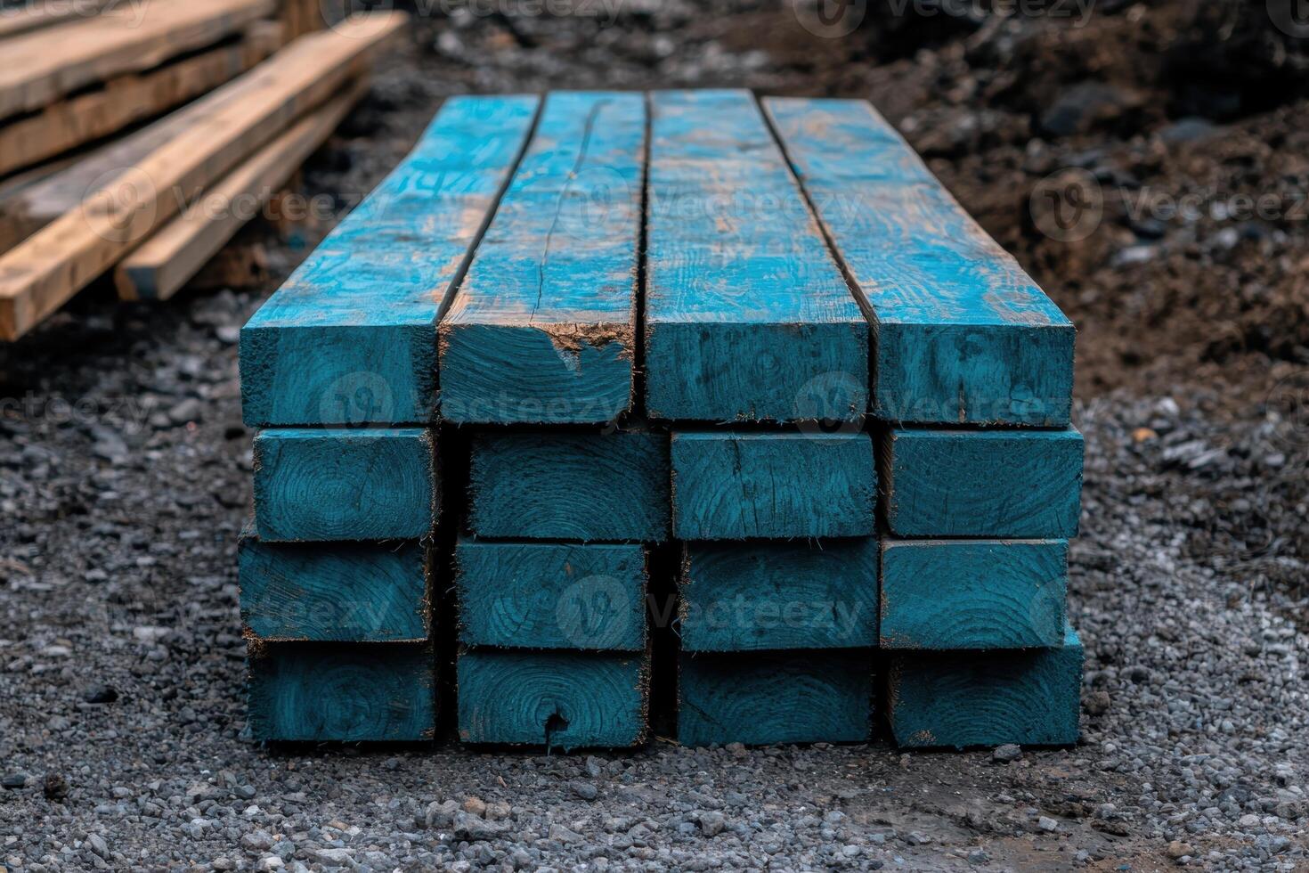 Stack of blue painted lumber on a construction site photo