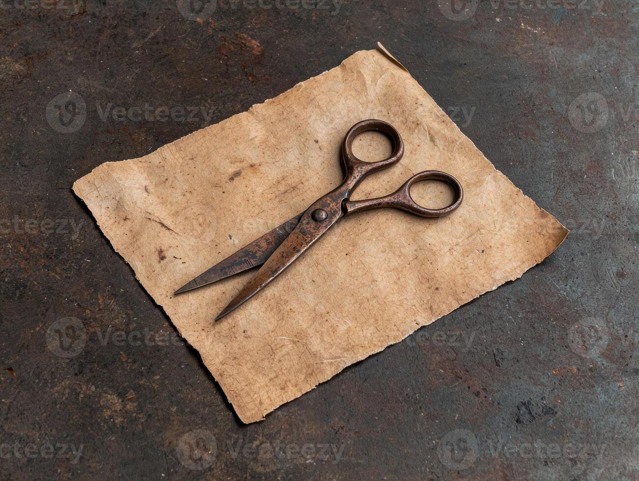 Rusty scissors on old paper photo