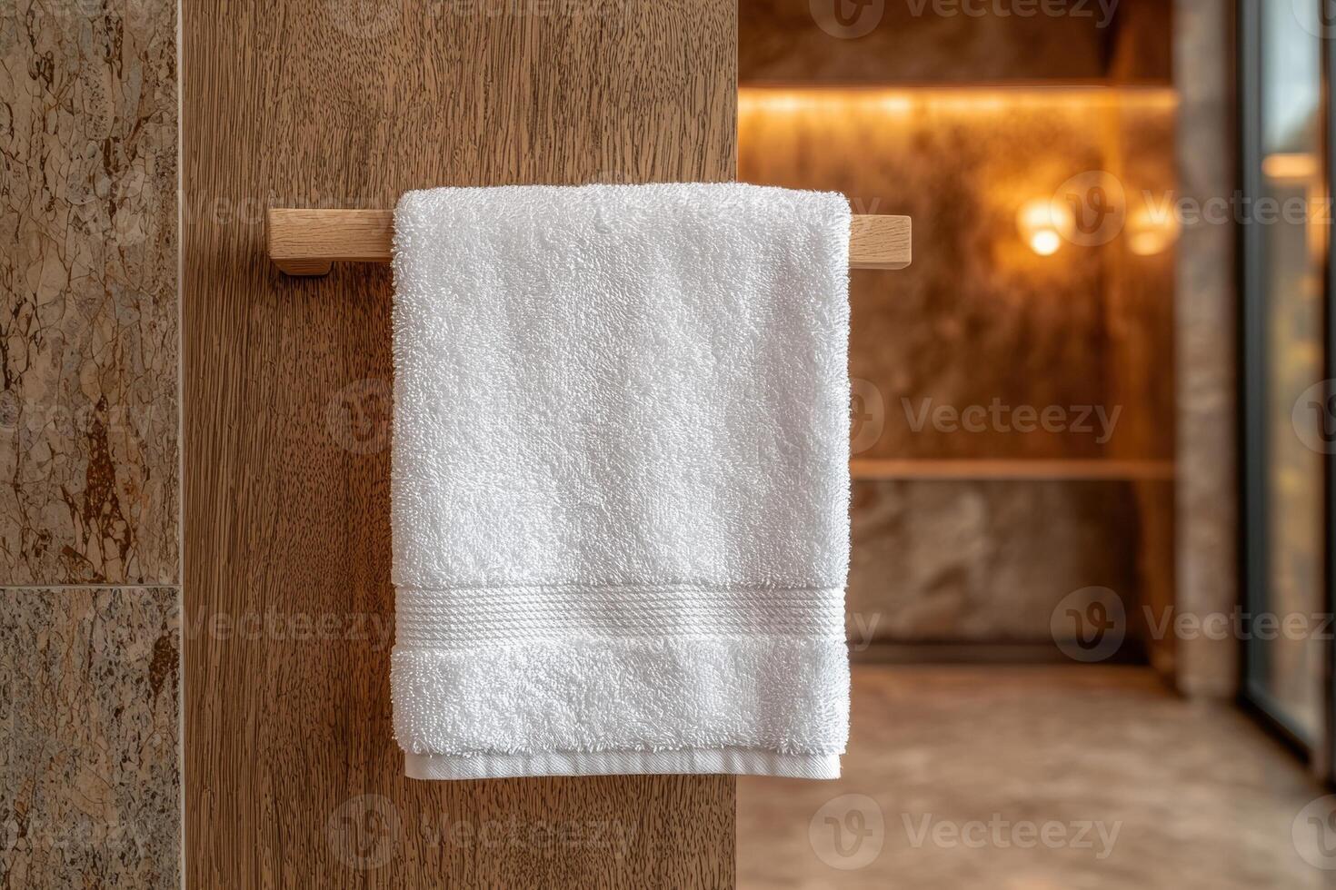 White towel hanging on wooden rack in modern bathroom photo