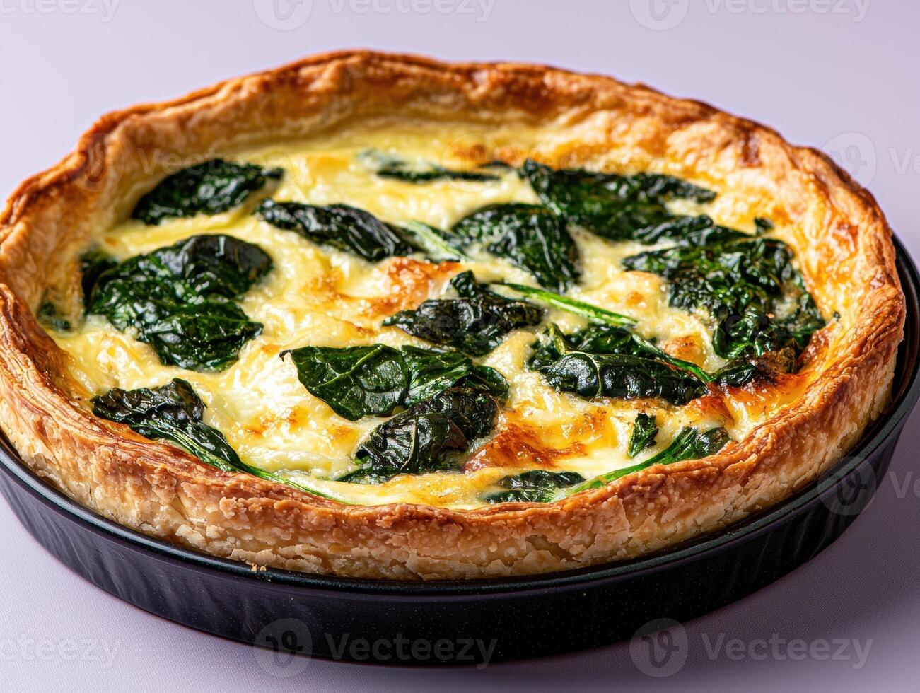 Delicious spinach and cheese quiche in a golden crust photo