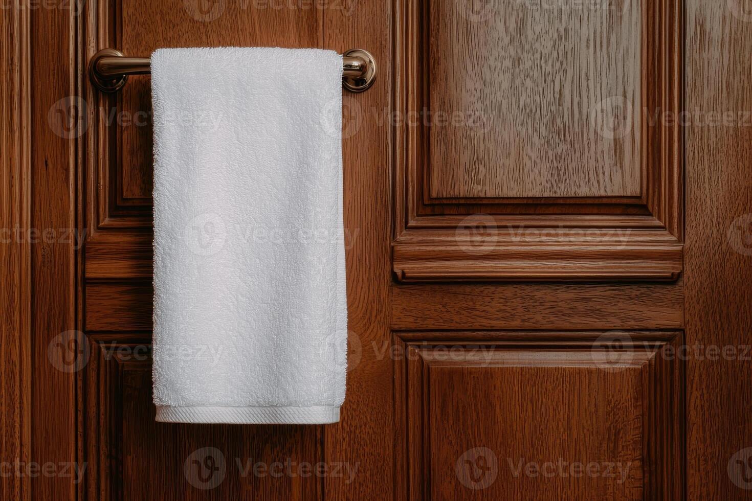 White towel hanging on a wooden door photo