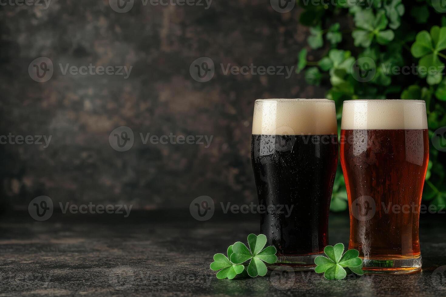 Two glasses of dark beer with shamrocks photo