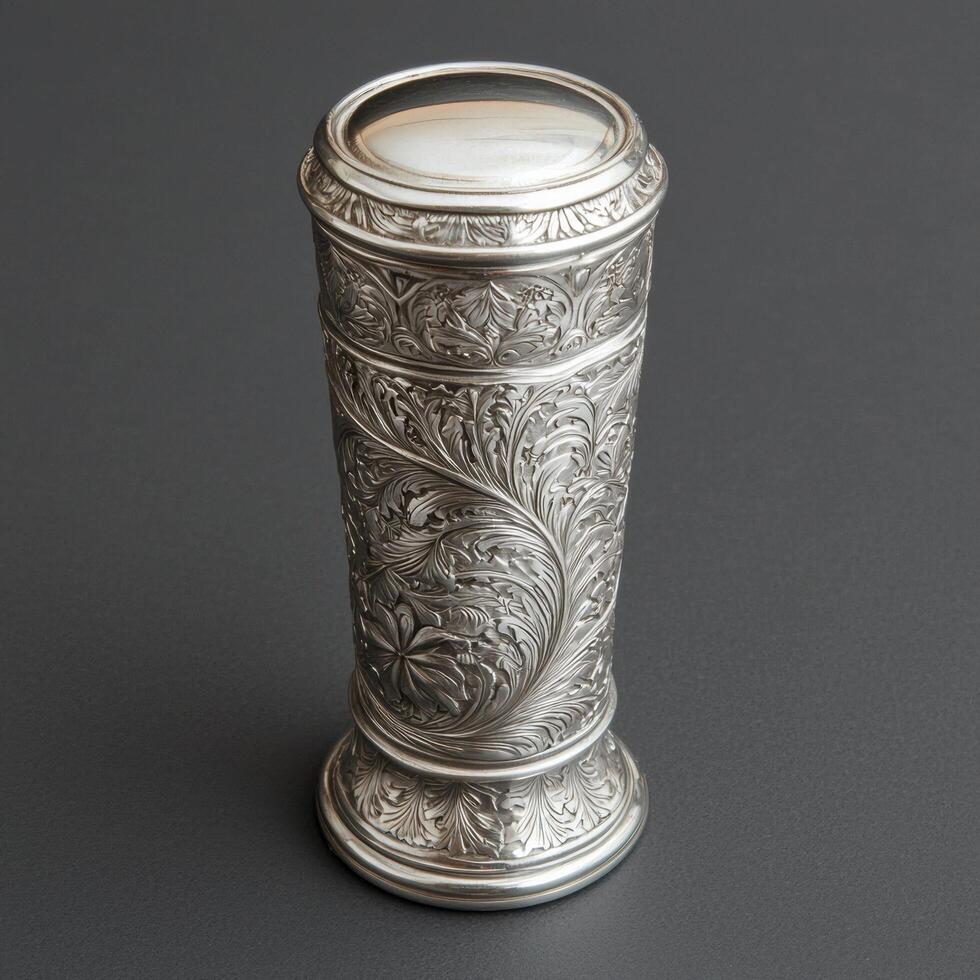 Ornate silver container with engraved floral design photo