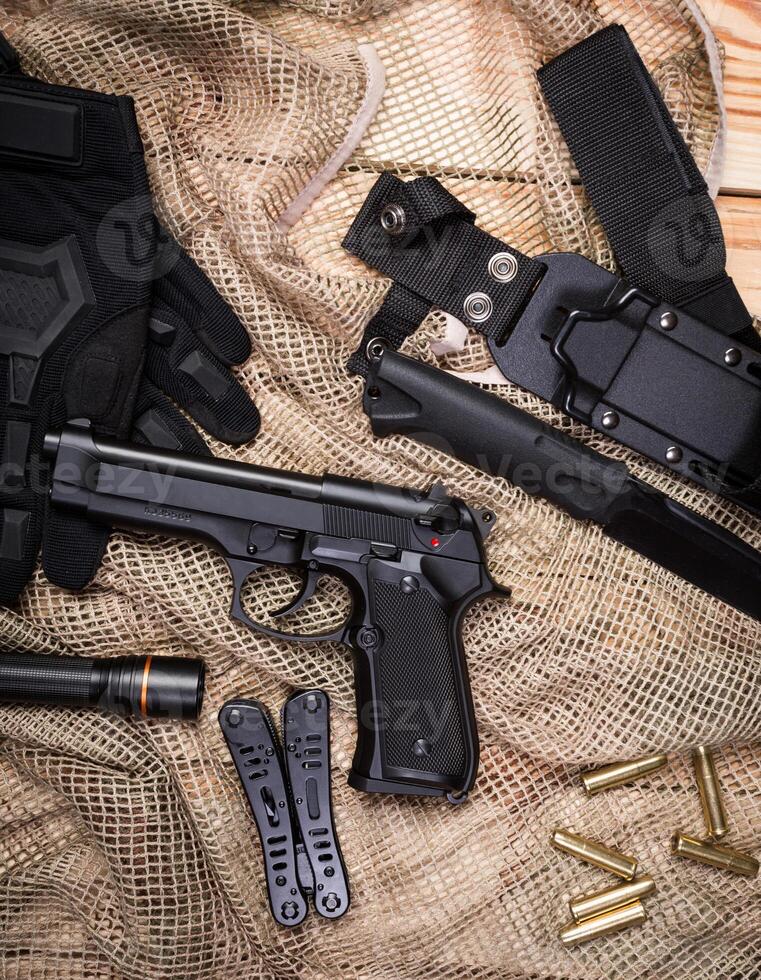 gun, knife with sheath, compass photo