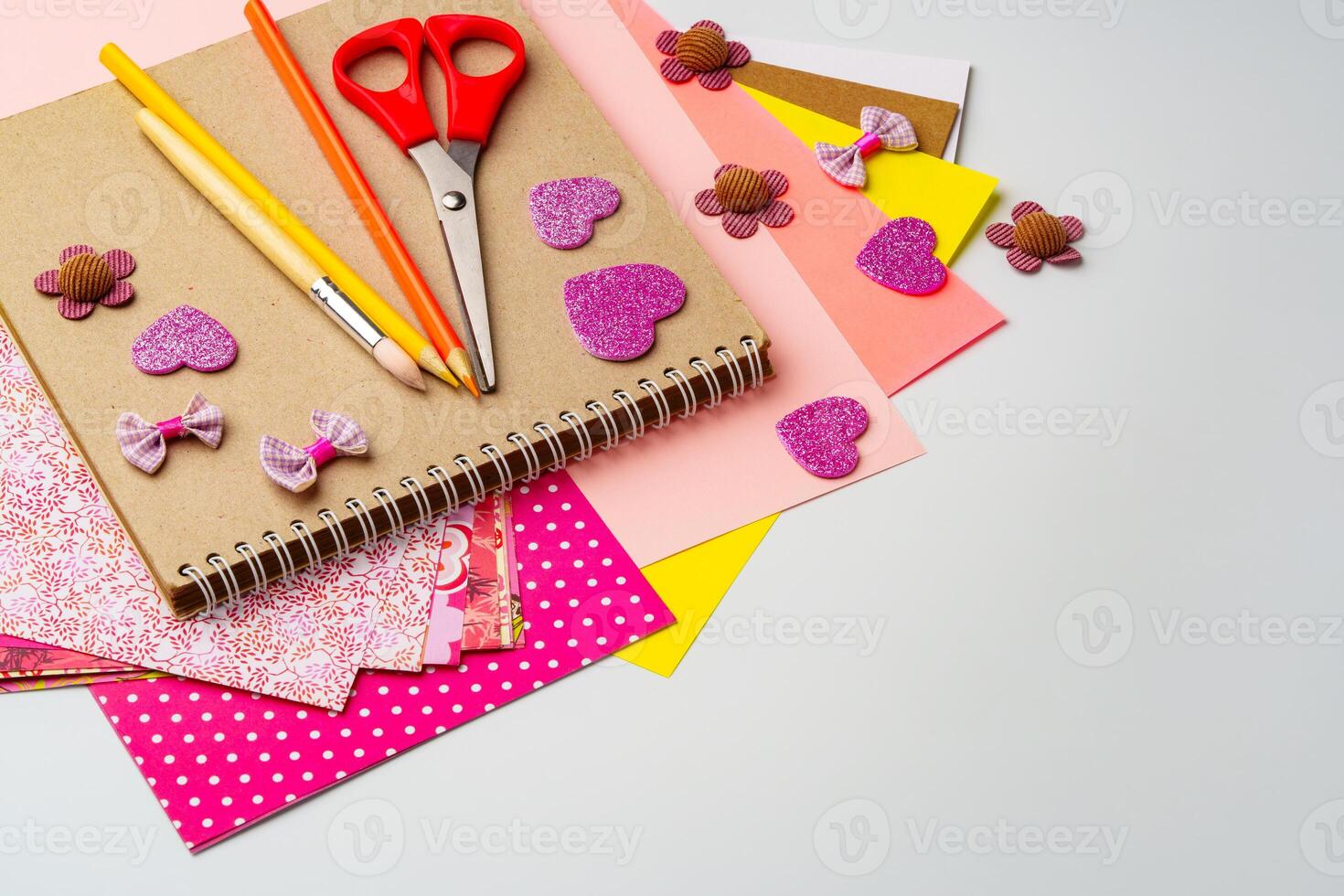 Crafting materials on a table showcasing colorful paper, scissors, and decorative embellishments for creative projects photo