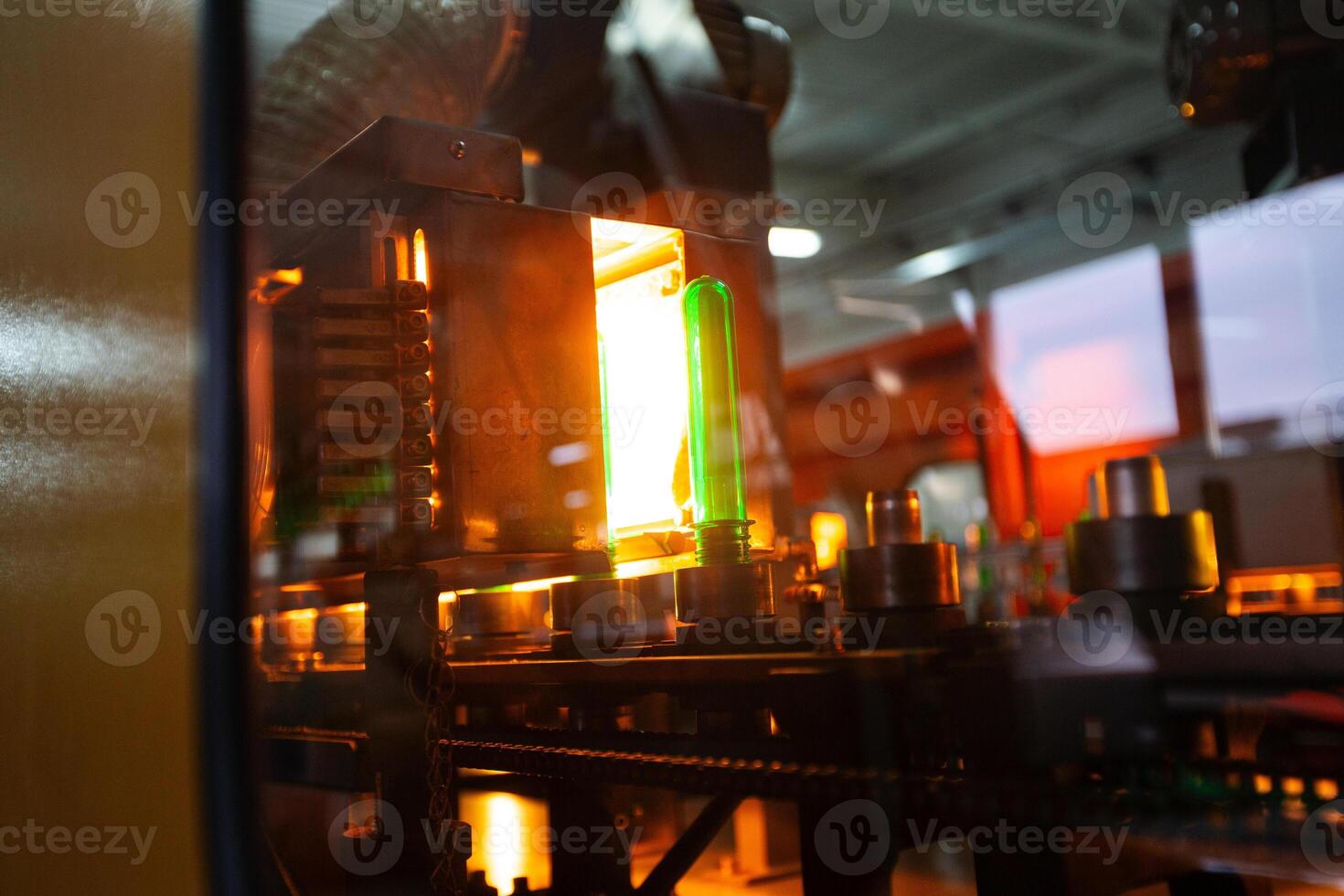 Manufacturing process showcasing a glowing green object in a modern industrial facility photo