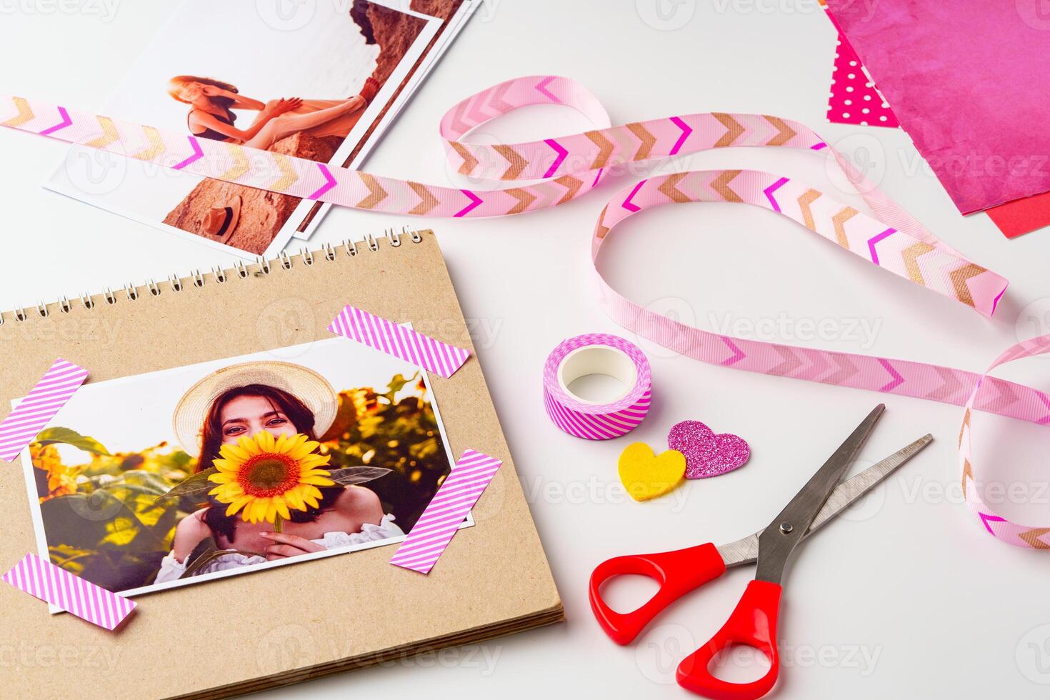 Creative scrapbook project showcasing a photo of a woman holding a sunflower with colorful decorations and crafting supplies