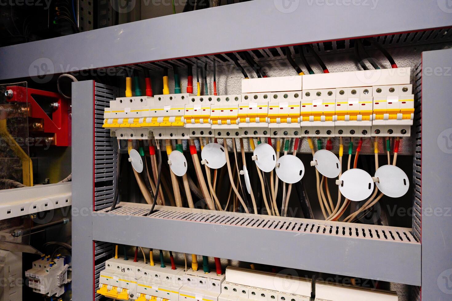 Detailed view of electrical panel with circuit breakers and wiring in a control room at a commercial facility photo