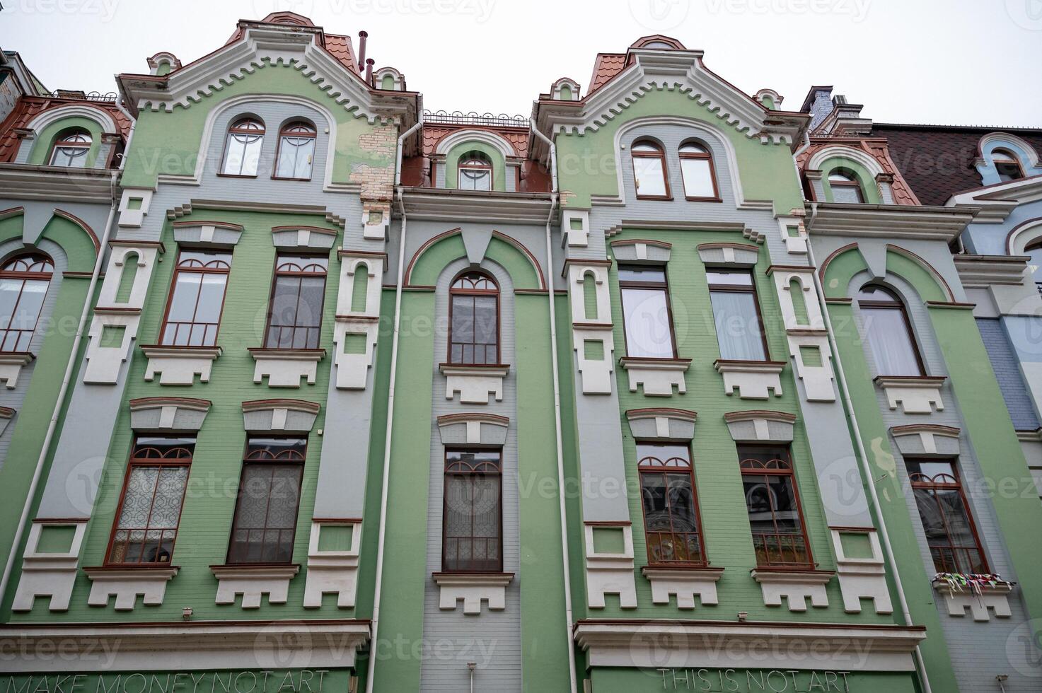 historical green building built in 1905. the wall of the building faces the street gothic-style building. close-up of the building. photo