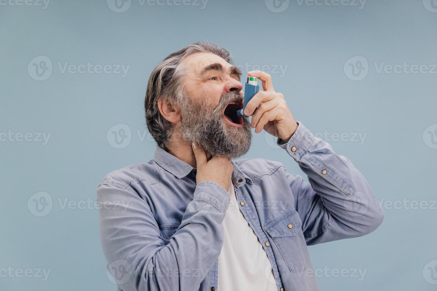 Senior Man Using Asthma Inhaler for Breathing Problems photo