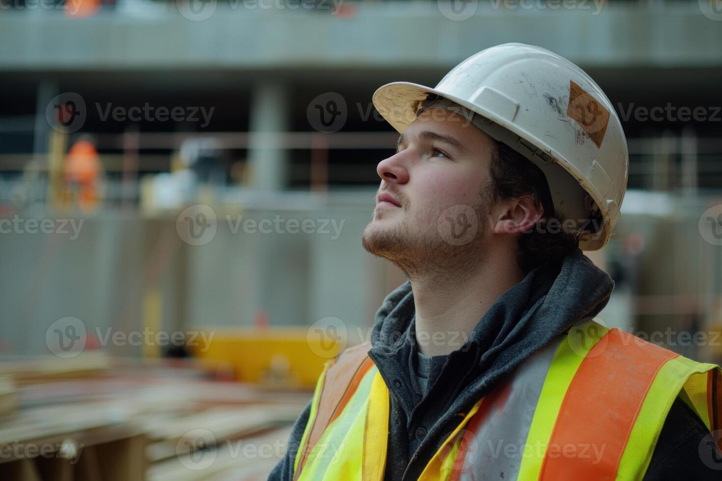 Construction worker observes safety measures while working on a building site during daylight hours photo