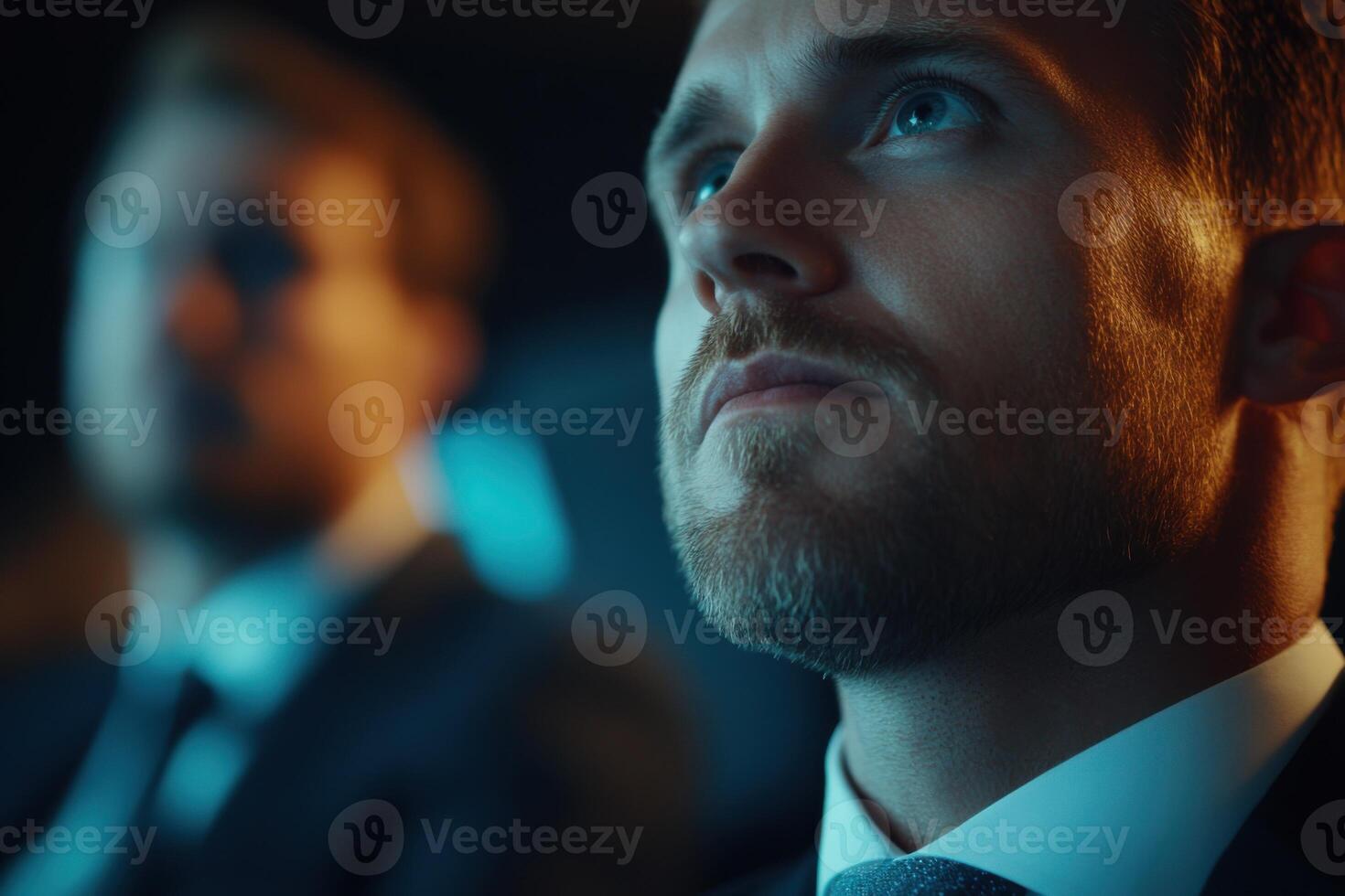 Focused expressions during an important meeting in a dimly lit conference room photo