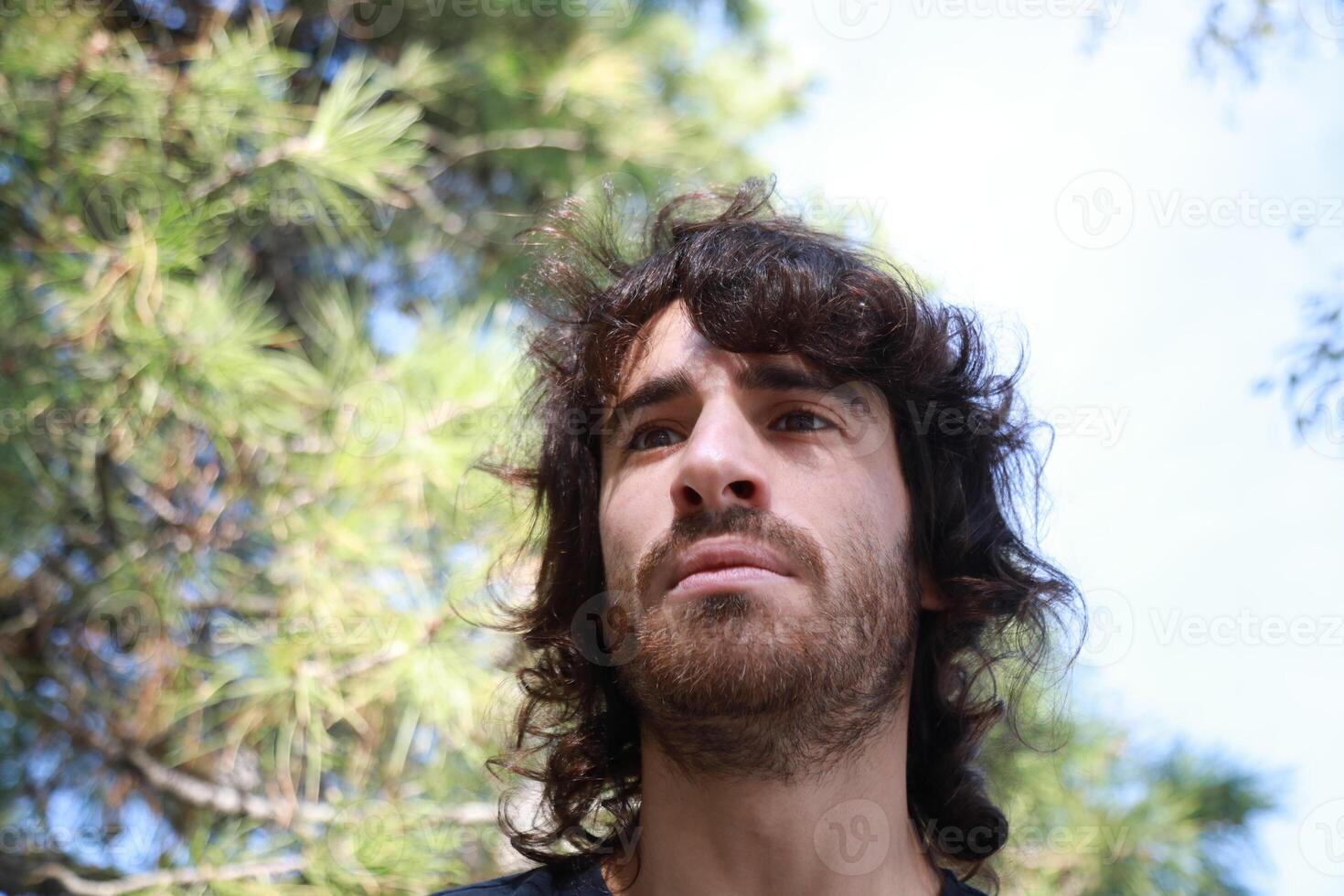 Sad Long Hair Man Is About To Cry From Depression In The Nature Park photo