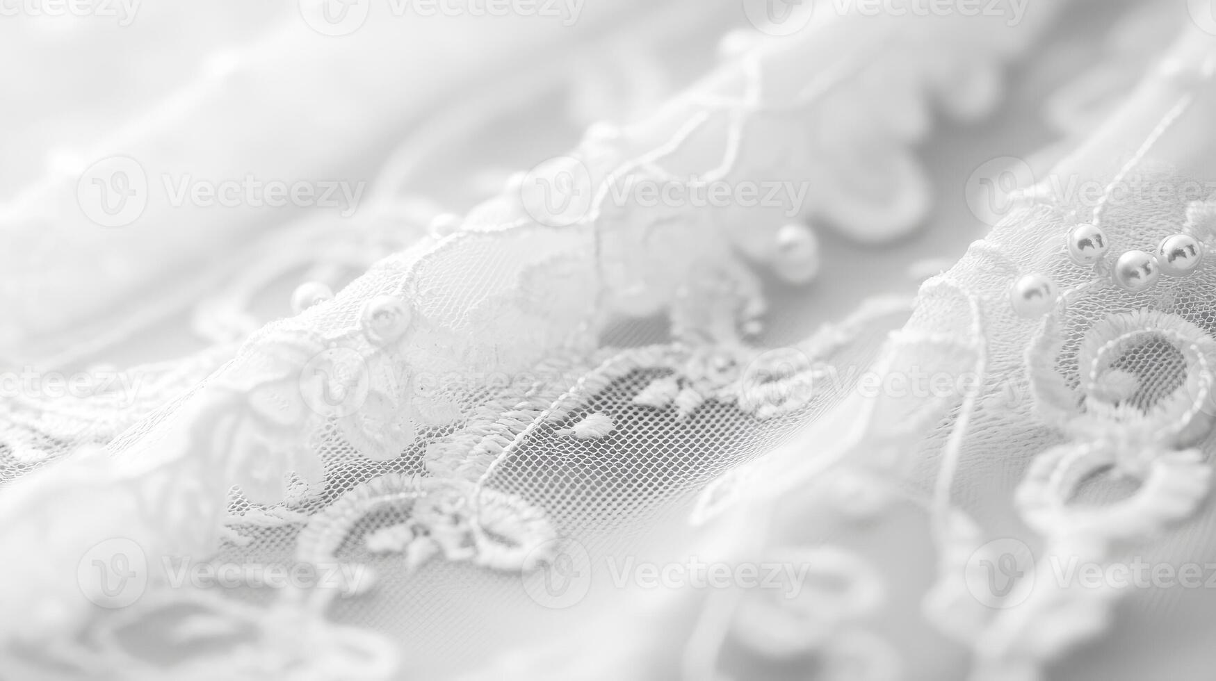 Delicate white lace fabric showcasing intricate patterns and details in soft lighting photo