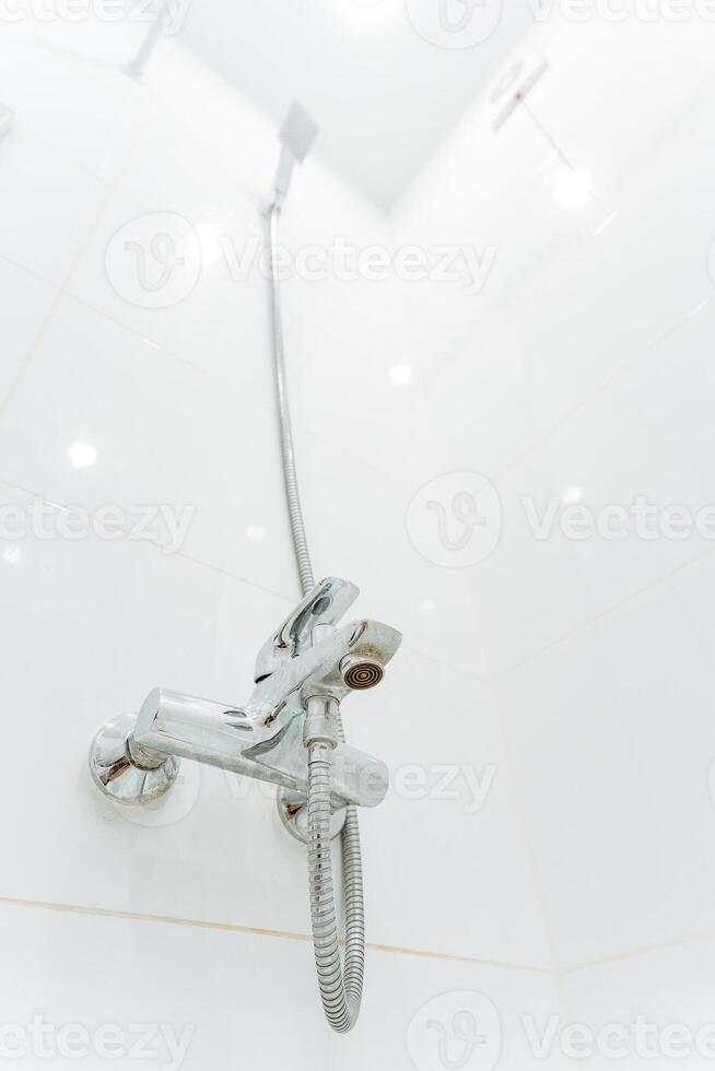 A shower head with a hose attached to it photo
