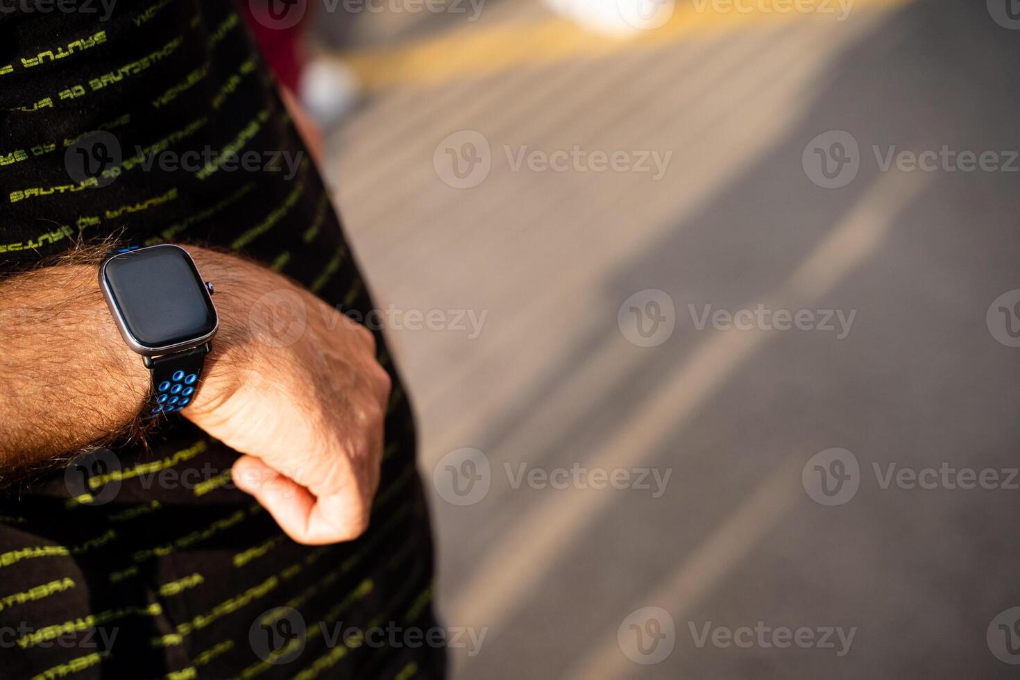 A man wearing a smart watch on his wrist photo