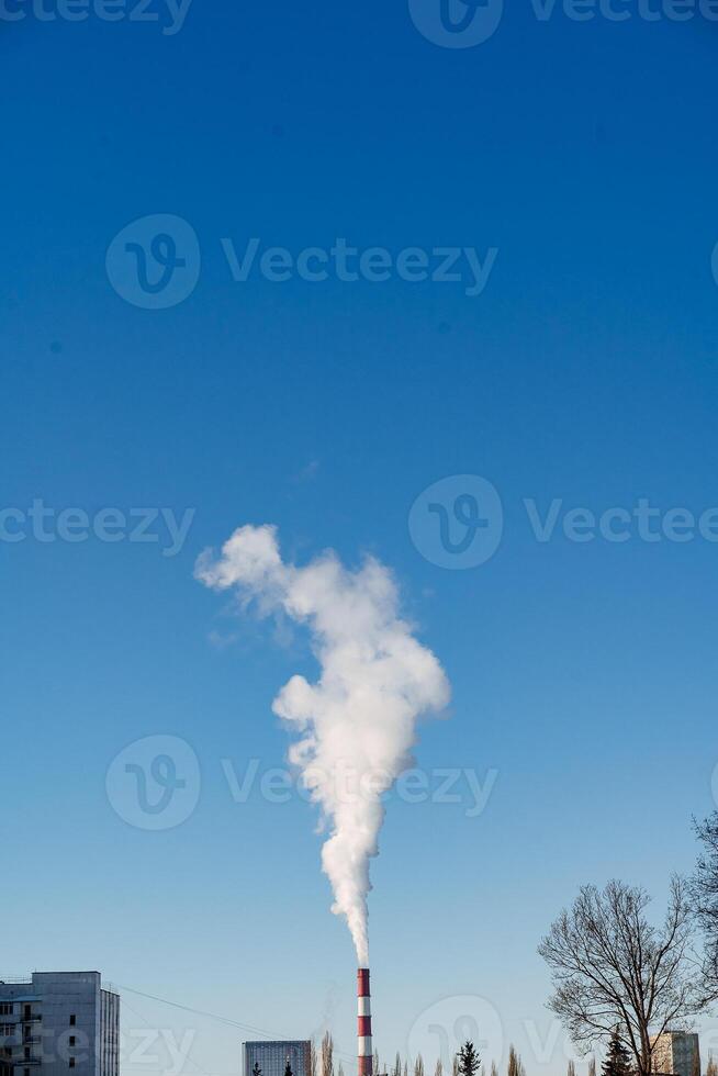 A factory with smoke coming out of it photo