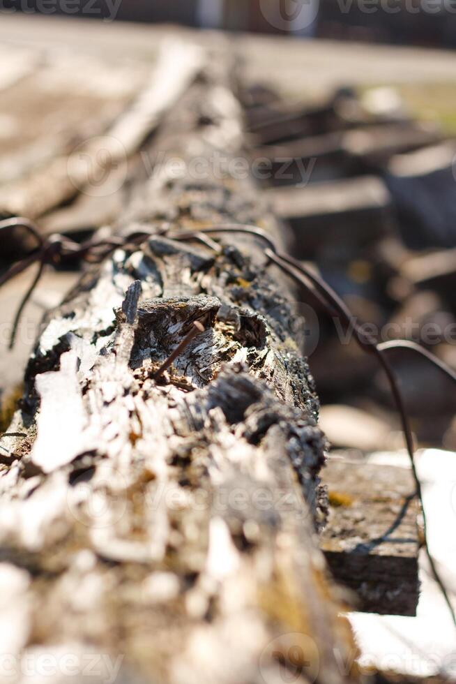 A close up of a wooden fence with a wire on it photo