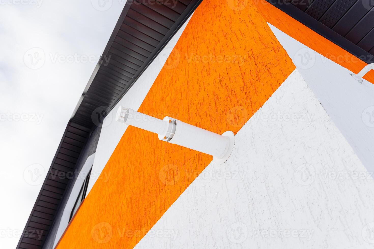 A white and orange building with a clock on it photo