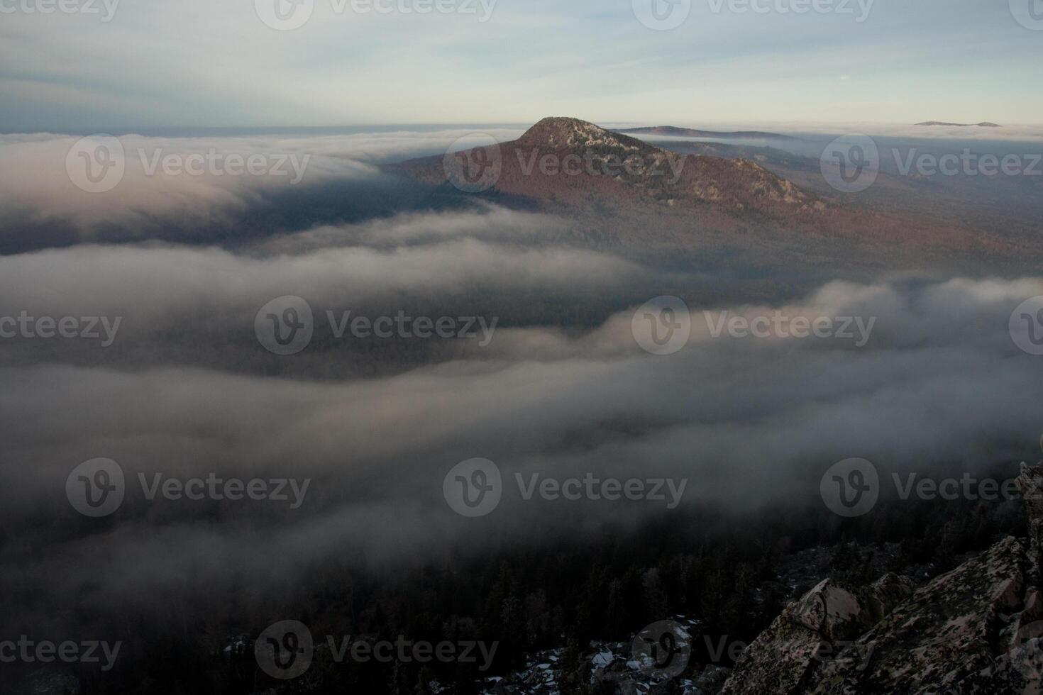 A view of the mountains and clouds from a mountain top photo