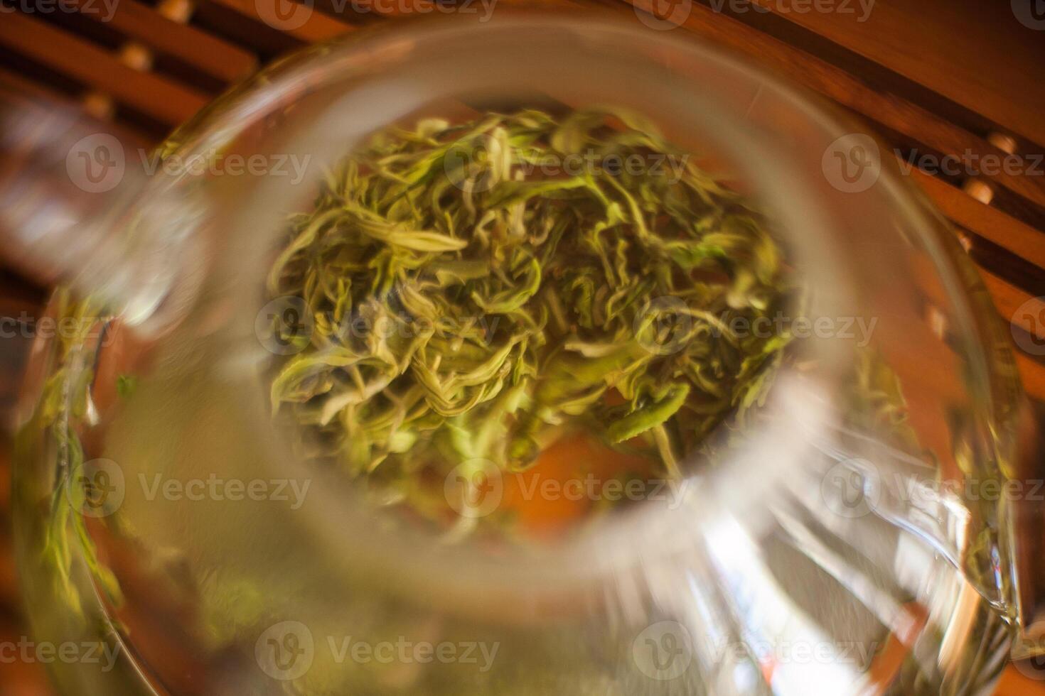 A close up of a tea pot with green tea photo