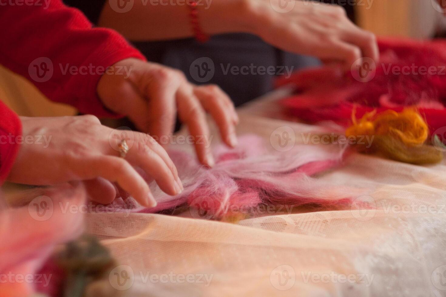 A woman is cutting a piece of fabric photo