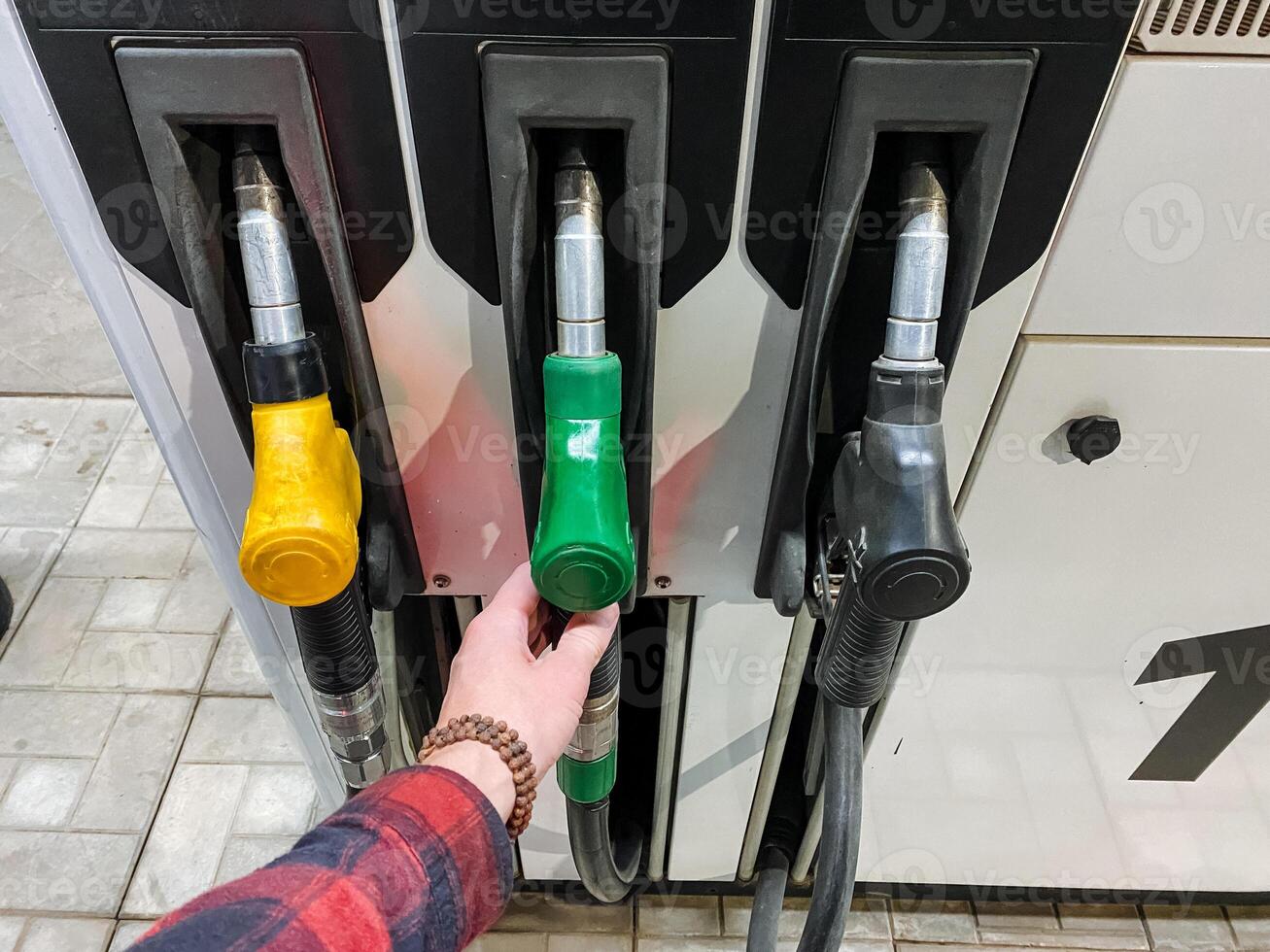 A person is holding a green and yellow nozzle photo