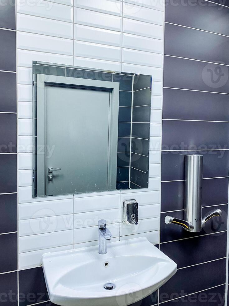 A bathroom with a sink and mirror in it photo