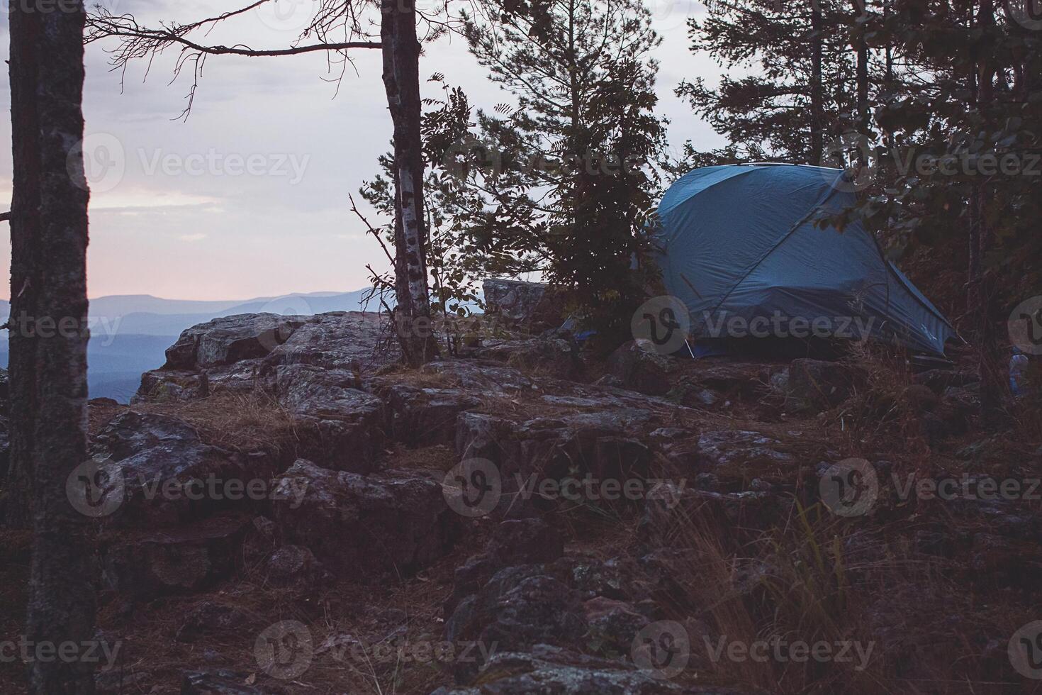 A tent on a rocky hillside photo
