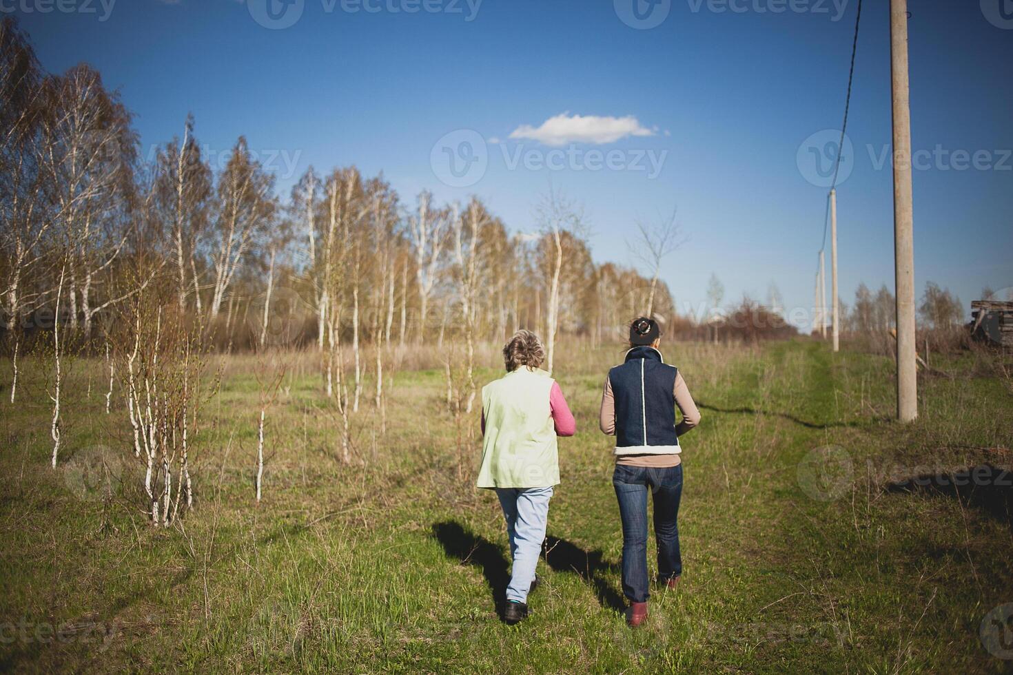 Two women walking in a field photo