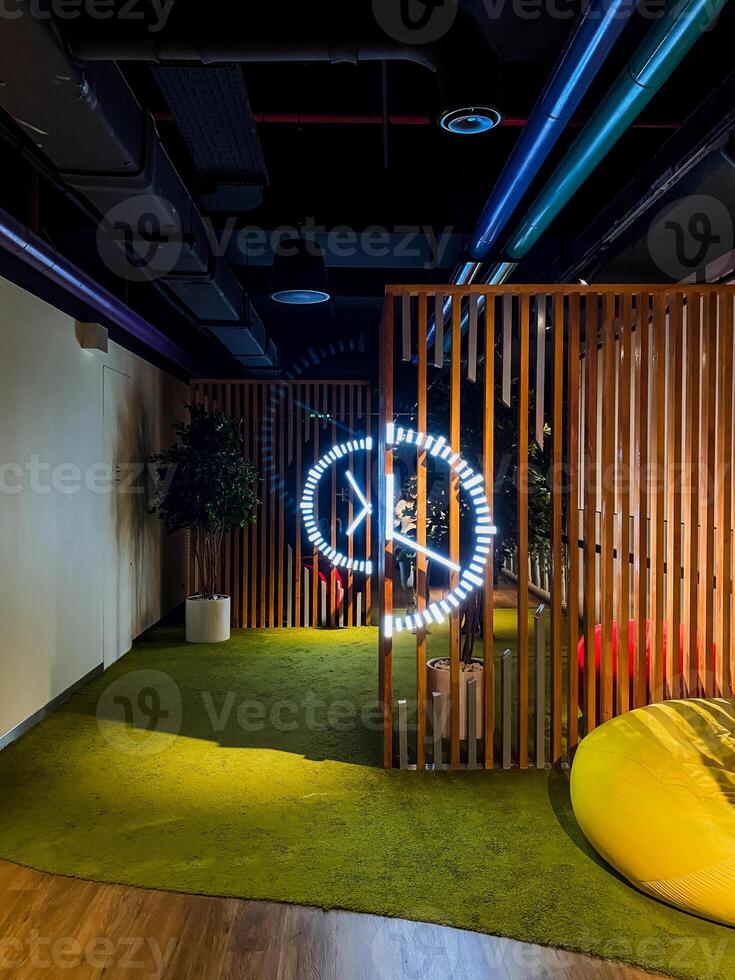 A room with a neon sign on the wall photo