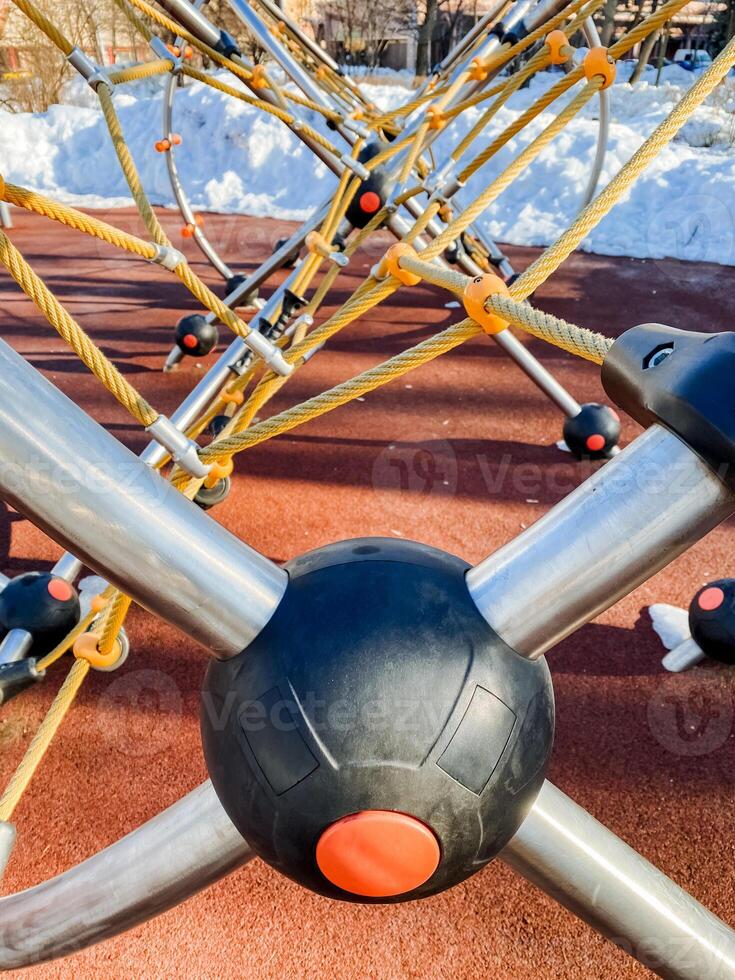A close up of a playground equipment with a ball photo