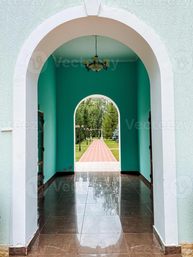 A doorway with a blue archway and a green door photo
