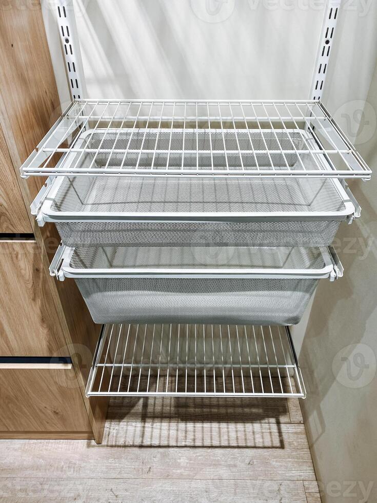 A white shelf with two baskets on it photo