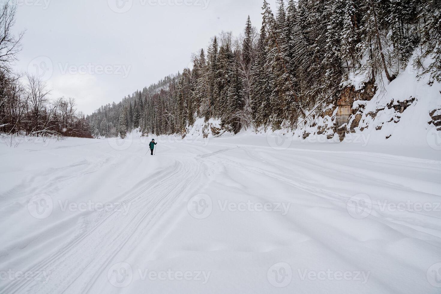 A person is skiing down a snowy slope photo